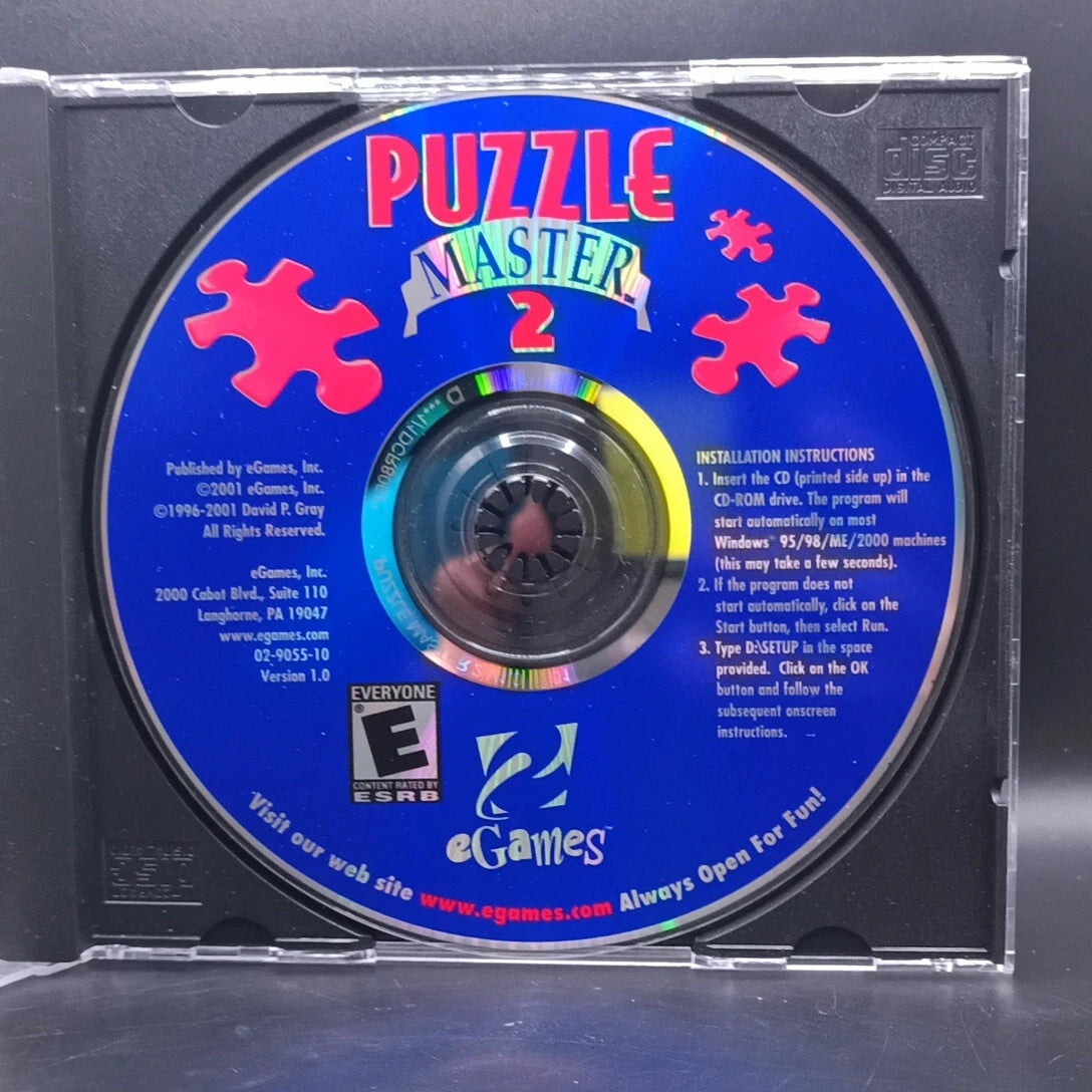 CD with 'Puzzle Master 2' on a blue label, featuring eGames branding.