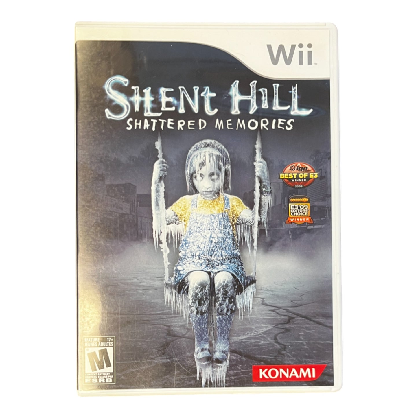 A Wii game case for 'Silent Hill: Shattered Memories' featuring a graphic of a child on a swing with a misty background.