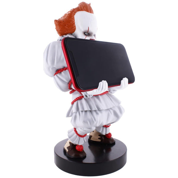 Figurine of a character with red hair and white outfit holding a black book on a white background