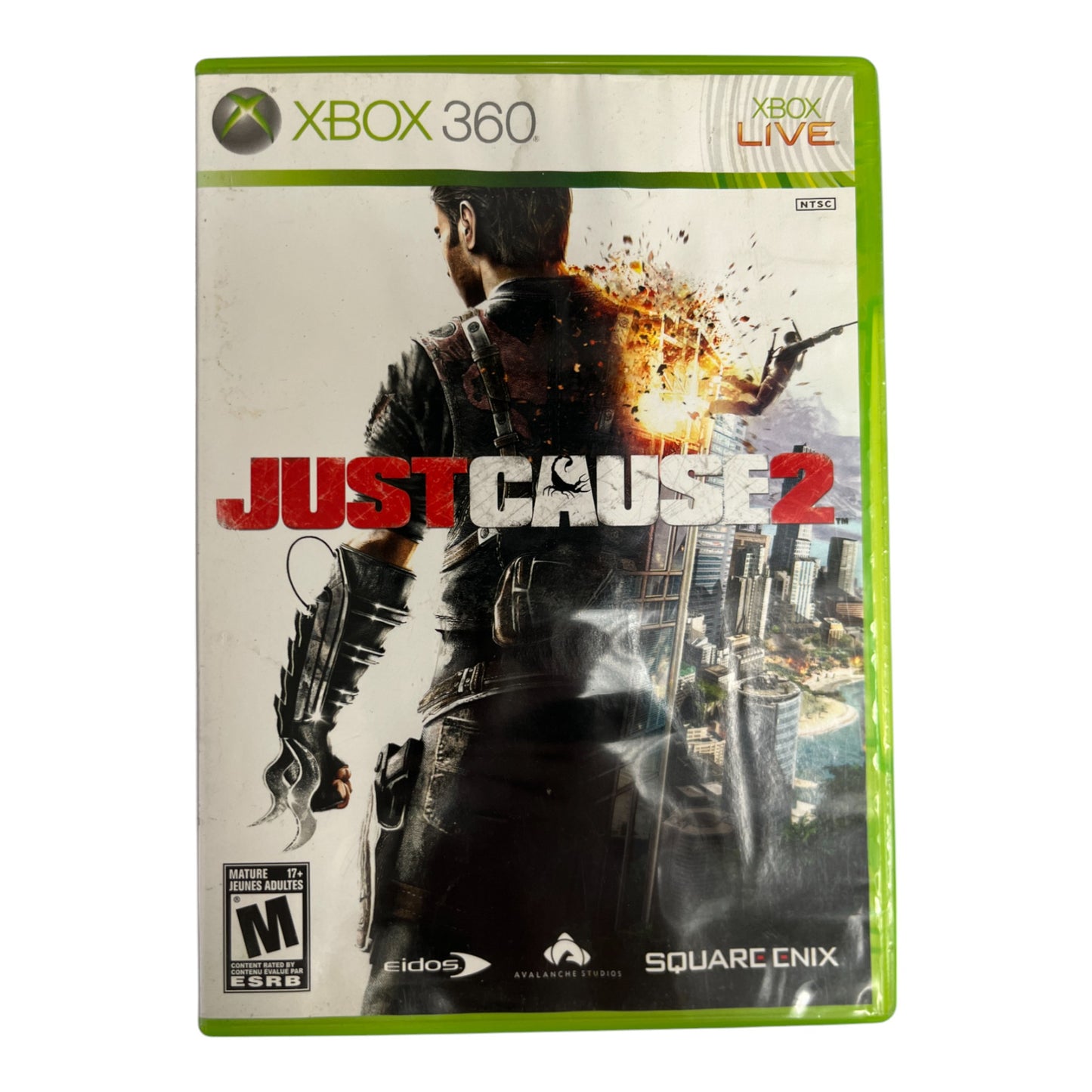 Xbox 360 game case for 'Just Cause 2' with a character holding a gun and cityscape in the background.