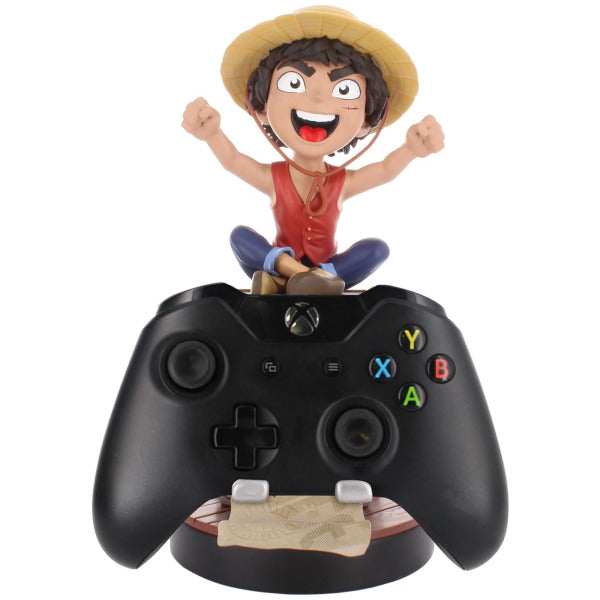 Gaming controller with a figurine of a character in a straw hat on top, on a white background