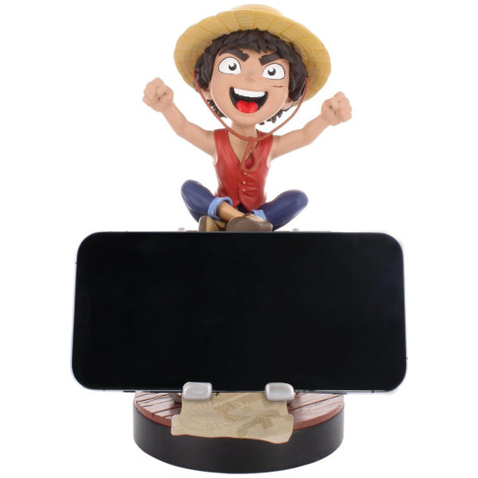 Phone stand with a character figurine on a white background