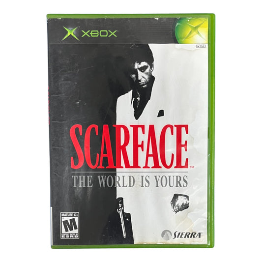 Xbox game case for 'Scarface: The World is Yours' with a stylized image of a character and text.