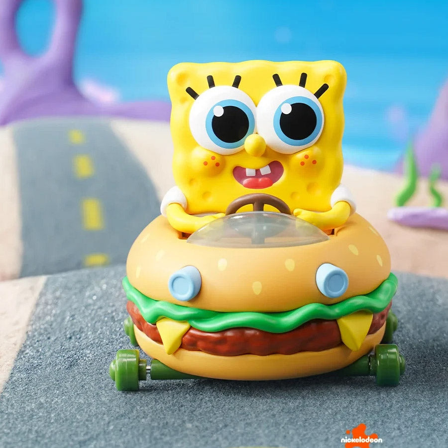 Toy figure of a cartoon character in a hamburger car with a colorful background