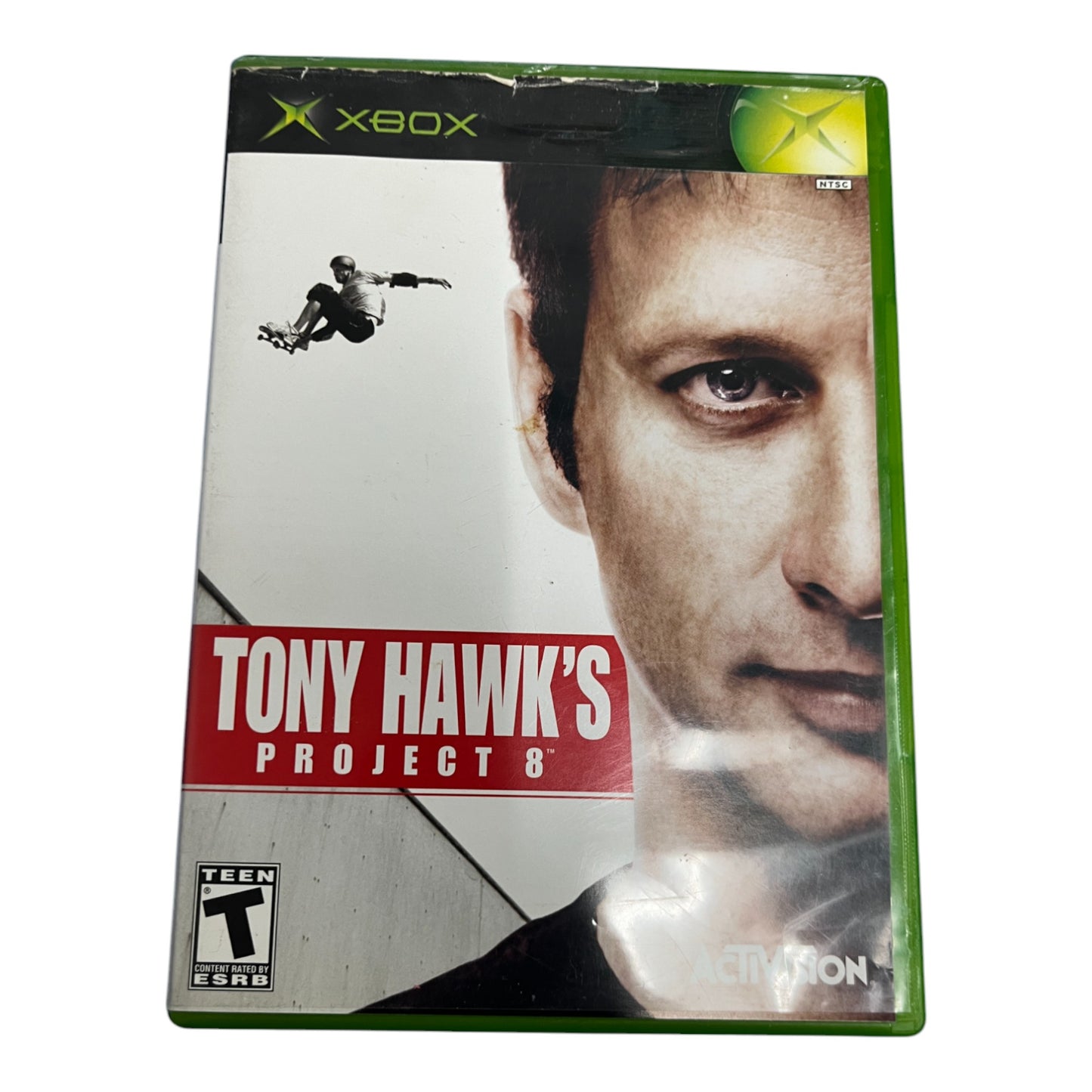Xbox game case for 'Tony Hawk's Project 8' with a close-up of a person's face and a skateboarder in the air.