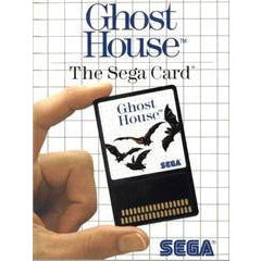 Sega card for 'Ghost House' with a hand holding it against a grid background